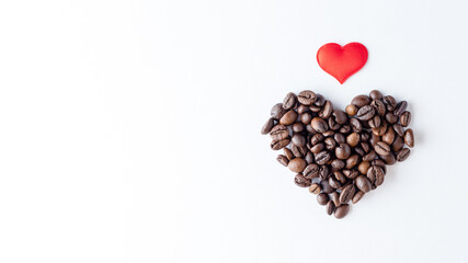 Symbol of love for coffee. Heart shape made from coffee beans and red heart on white background, close up, top view, flat lay, copy space, banner