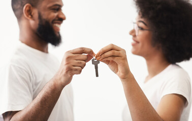 Black Couple Holding New House Key Standing Over White Background