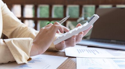 Accounting businesswomen are calculating income-expenditure and analyzing real estate investment data, Dedicated to the progress and growth of the company, Financial and tax systems concept.