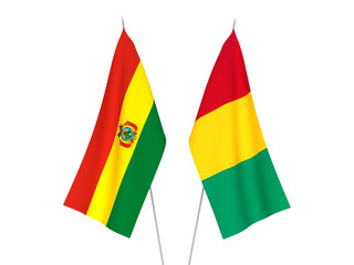 National fabric flags of Guinea and Bolivia isolated on white background. 3d rendering illustration.