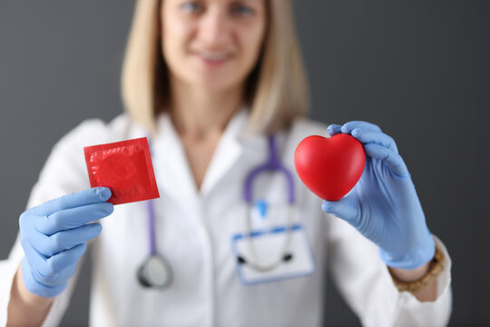 Doctor holds condom and heart in his hand
