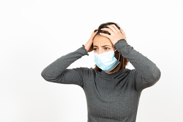 Depressed latin woman wearing a medical face mask. Mental health and anxiety during Coronavirus pandemic concept.