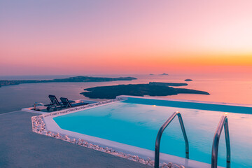 White architecture on Santorini island, Greece. Sunset view over infinity swimming pool in luxury...