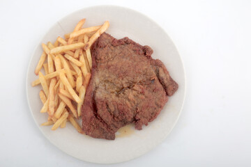 veal breaded meat with fried potatoes