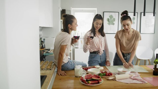 Video of women having time with homemade pizza and wine.  Shot with RED helium camera in 8K