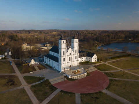 Aerial view of Aglona Roman Catholic Basilica of the Assumption of the Blessed Virgin Mary. Latvian landmark. Scenic forest and lake.