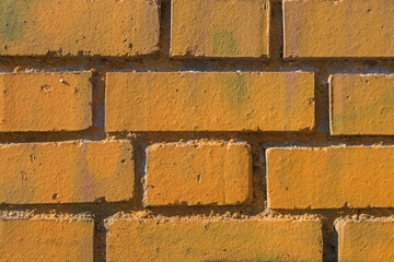 background with a large brick wall painted orange