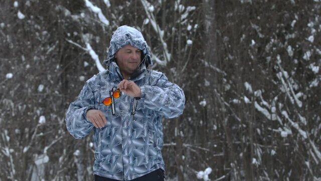 Man stands alone against white snowstorm and snow storm, a snowfall.
