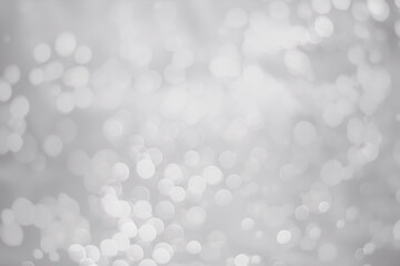 White glitter vintage lights background. White bokeh background.