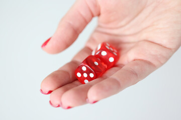 On hand are red dice with white marks