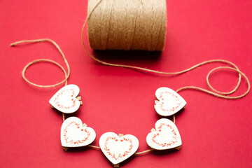 Wooden hearts, isolated on a red background.