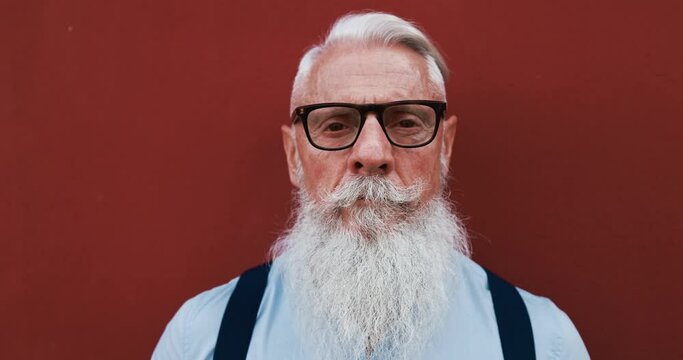 Hipster trendy man with serious expression - Close up of bearded senior guy - Fashion and elderly lifestyle concept 