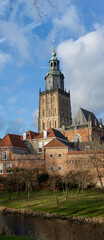 Bookmark elongated panorama with tower of the Walburgis church towering over the rooftops of medieval housing of the Hanseatic city Zutphen in The Netherlands against a blue sky with clouds