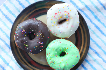 chocolate donuts on plate with copy space 