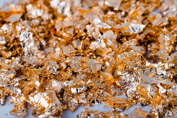 Gold foil metal flakes shiny textured background