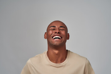 Multiethnic person laughing out loud with raised head