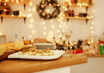 Still life on rustic wooden table. French food tasting party or feast scenery. Different kinds of cheeses, wine and snacks. Food for wine and romantic, cheese delicatessen. Menu design horizontal
