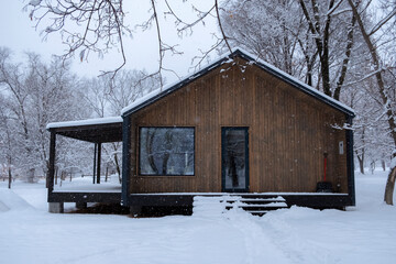 Cozy modular simple house in winter forest. Hygge lifestyle concept. Winter season. Eco-friendly...