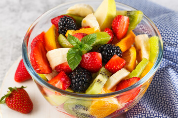 Delicious fruit salad on a plate on table.