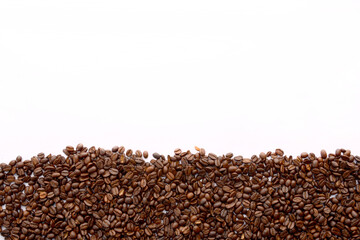 Roasted coffee beans against a white background.