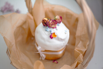 Traditional russian easter cake on table. The decorarion of kulich are the flower are eating on spring holiday