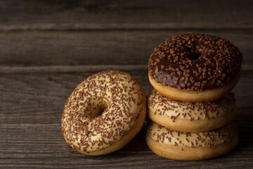 Ring doughnuts covered with vanilla and chocolate glaze, topped with sprinkles.

