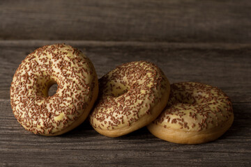 Delicious ring donuts covered with vanilla, topped with sprinkles.