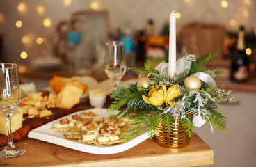 Luxury romantic candlelight dinner table setup for couple. Stylish table setting with burning candles and Christmas decorations. Wine glasses and beautiful food decoration. Romantic fine dining