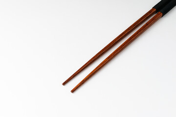 Wooden chopsticks on white background