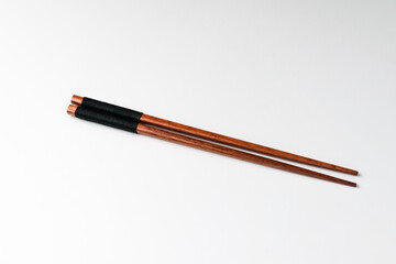 Wooden chopsticks on white background
