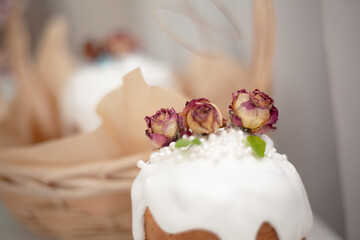 Traditional russian easter cake on table. The decorarion of kulich are the flower are eating on spring holiday