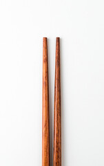 Wooden chopsticks on white background
