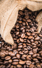 
The coffee beans in the sack spill onto the ground.