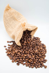 
The coffee beans in the sack spill onto the ground.