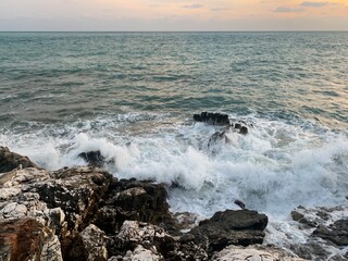 Sunset at the sea, rocky coastline, natural colors