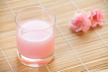Pink tea. Beverage for summer with wooden background.