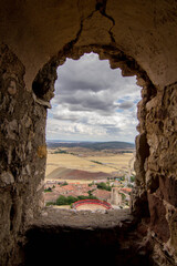 Spanish old castle window in an arid region landscape