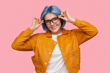 Smart female adjusting sunglasses and smiling