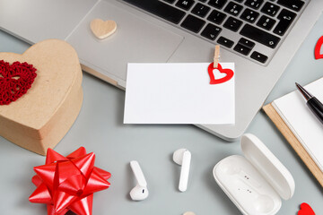 Valentines day present and blank card near modern gadgets