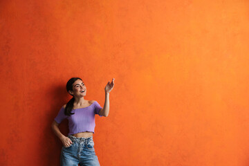 Portrait of cheerful young woman prsenting copy space