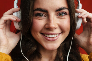 Young happy woman listening to music with headphones