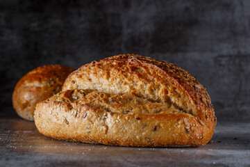 Assortment of baked bread on wooden table background Fresh fragrant bread on the table. Food concept.