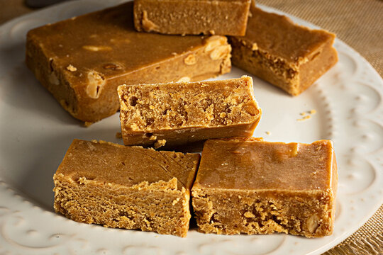 Pa&ccedil;oca, Brazilian Typical Peanut Candy on Wooden Table and a Plate