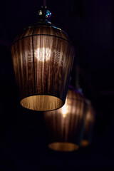 Ceiling lamps with warm light on a dark background. Decorative room lighting