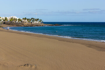 Empty beach on sunny day in Puerto del Carmen, Lanzarote