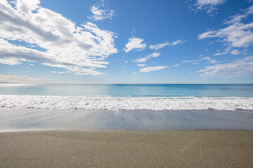 Blue sea water waves with white foam and bubbles washes the beach. Winter see. Riva Trigoso on ligurian coast