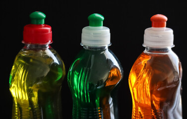 plastic bottles of 3 differently colored and fragranced dishwashing liquids