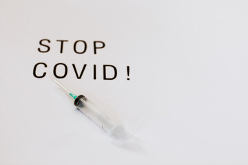 Creative design for Coronavirus vaccine background. Top view of syringe laying on white background with copy space.