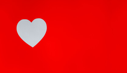 Top view of white heart on red background with copy space. Design for St. Valentine's day.