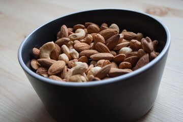 Background of mixed nuts - hazelnuts, walnuts, almonds - with copy space. Isolated one edge. Top view or flat lay